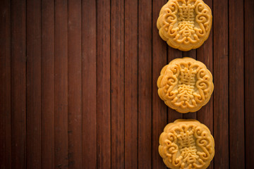 Moon cakes on bamboo mat dark light with copy space