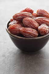 Fresh Medjool Dates in a bowl. Ramadan kareem. Black background. Copy space.