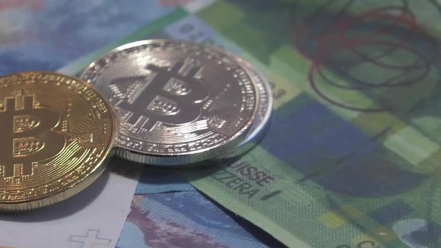 Physical metal Bitcoin currency over bolivar bills. Virtual internet money with Venezuelan banknotes. Digital coin cyberspace, cryptocurrency. BTC golden coin as symbol of electronic virtual money. 4K