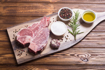 Raw beef steak T bone with ingredient