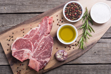 Raw beef steak T bone with ingredient