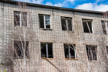 Broken Windows and glass in an old, abandoned brick house