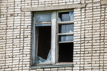 Broken Windows and glass in an old, abandoned brick house