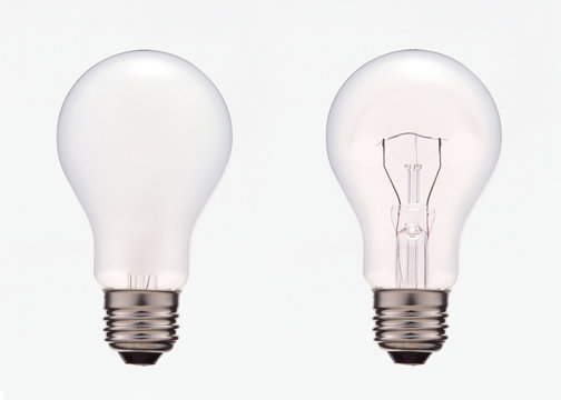 Two electric light bulbs with and without filament, isolated on white background with clipping mask.