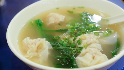 Shrimp Dumpling soup with green vegetable in the bowl