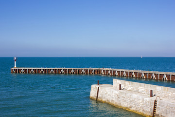 Obraz premium Landing stage and landmark in the Atlantic, France; Ile de Re