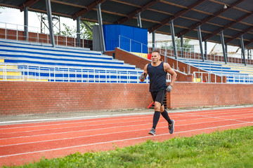 a man in a t-shirt running around the stadium