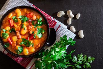 White bean soup with potatoes, tomatoes, paprika, and bacon