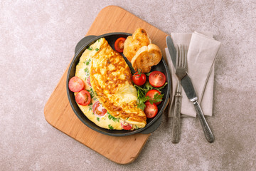 Herb omelette with tomatoes and panini toasts.  Breakfast