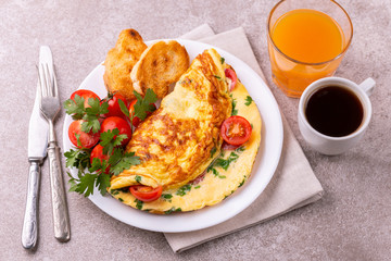 Herb omelette with tomatoes and panini toasts. Coffee. Breakfast