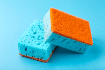 Sponges for dishwashing. Kitchen equipment. Blue background