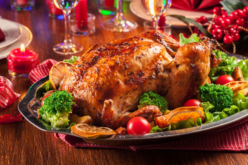 Baked or roasted whole chicken on Christmas table