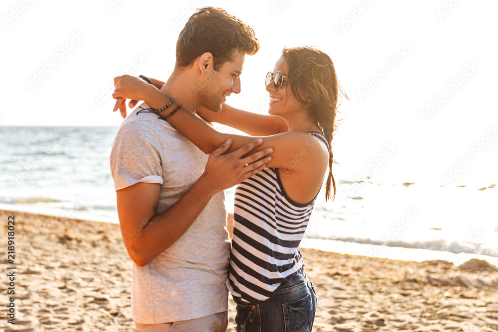 Sticker cute loving couple hugging on the beach outdoors.