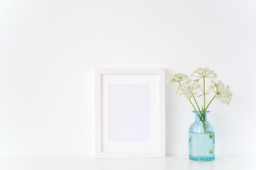 Modern white portrait a4 frame mock up with a wild host in blue vase. Mockup for quote, promotion, headline, design. Template for small businesses, lifestyle bloggers, social media. poster