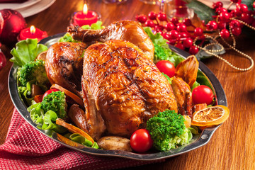 Baked or roasted whole chicken on Christmas table