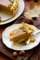 Homemade pumpkin pie with cinnamon on brown paper background. Thanksgiving day or Halloween holiday concept