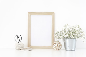 Wood frame mockup A4 in interior. Tin can with bouquet of white flowers . Frame mock up poster or photo frame for bloggers, social media, lettering, art and design. Background.