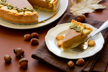 Homemade pumpkin pie with cinnamon on brown paper background. Thanksgiving day or Halloween holiday concept