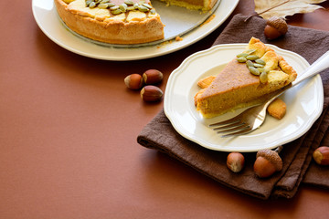 Homemade pumpkin pie with cinnamon on brown paper background. Thanksgiving day or Halloween holiday concept