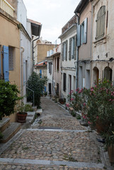 Fototapeta na wymiar Steps and narrow street in the old town of Arles in Provence in the South of France.