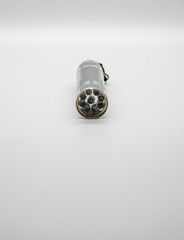 Silver metal flashlight isolated on white background