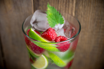 Raspberry mojito cocktail on the wooden background. Selective focus. Shallow depth of field.