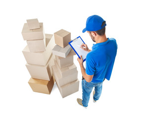 Top view of delivery man taking notes near stack of parcels boxes