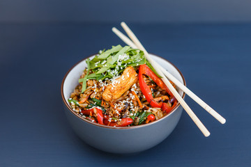 A plate of a wok rice on the dark background