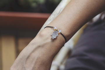 Female hand wrist resting with tiny jewelry