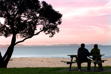 Fototapeta na wymiar Young couple watching the sunset