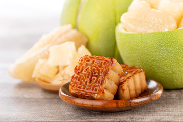 fresh and peeled pomelo(shaddock), grapefruit with slices and mooncake in mid-autumn festival(moon festival)