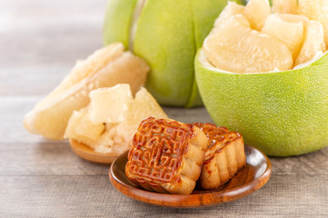 fresh and peeled pomelo(shaddock), grapefruit with slices and mooncake in mid-autumn festival(moon festival)