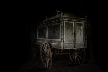 Fototapeta na wymiar Old and dusty hearse carriage