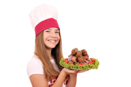 happy little girl cook with meatballs on plate