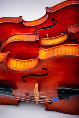 Obraz premium Three violins on a wihte background