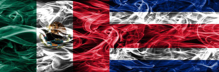 Obraz premium Mexico vs Costa Rica smoke flags placed side by side. Mexican and Costa Rica flag together