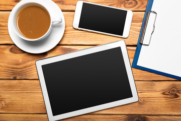 Fototapeta na wymiar digital tablet and coffee cup on wooden table