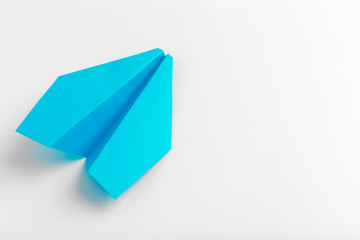 Flat lay of white paper plane on white color background