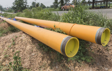 Plastic Drainage Pipe on a Construction Site .Yellow plastic pipe transfer water system aligned on...