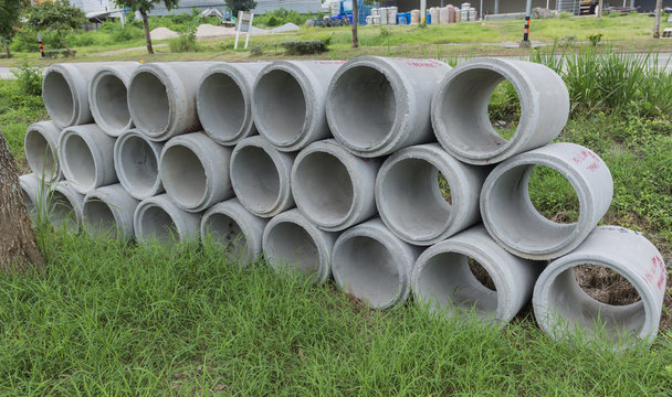 Pile of Concrete Drainage Pipe on a Construction Site .Concrete pipe stacked sewage water system aligned on site.