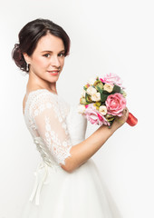 elegant bride with beautiful wedding bouquet in a hands. wedding make-up and hairstyle concept