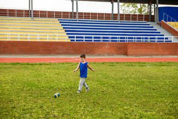 boy runs around with the ball on a football field