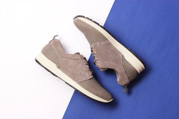 men's sneakers on a colored background top view. men's footwear. minimalism