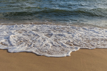Wave of the sea on the sandy beach