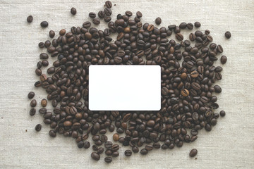 Good morning! Coffee beans are scattered on the table. Light textured background, toned photo. Copy space