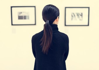 Woman looking at the art exhibition