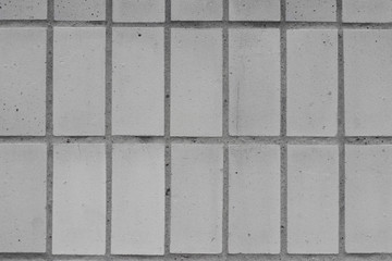 white brick tiles wall pattern of modern vignette ideal for a background and used in interior design.
