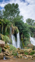 Fototapeta na wymiar A waterfall and a tree in Kravica, Bosnia