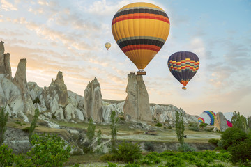 Interesting rocky terrain and a lot of airy multicolored balls in the air. Turkey. Cappadocia. Goreme National Park.
