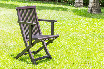 Black wooden chairs on the lawn.